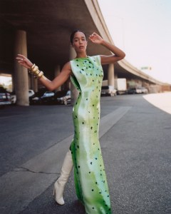 Bottega Veneta’s printed sequined dress and leather boots. Alexis Bittar gold bangles.
