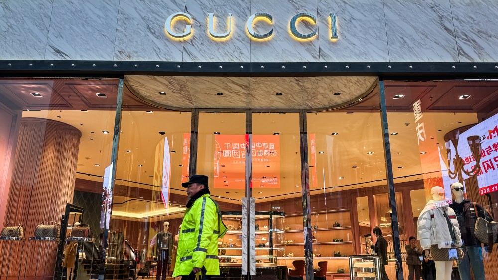 A illuminated storefront of a Gucci store in Chongqing.