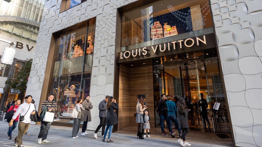 Tokyo, Japan - November 23, 2023 : Pedestrians walk past the Louis Vuitton store in Ginza, Tokyo, Japan.