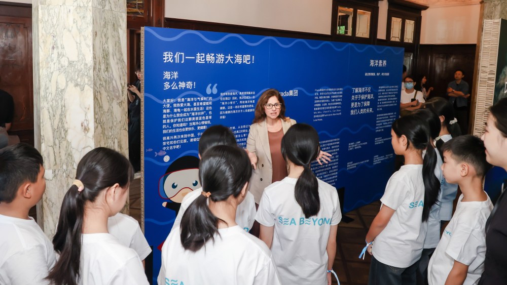 Francesca Santoro, IOC Senior Programme Officer with children from the inland Guizhou province, who have never seen the ocean, at the Prada Sea Beyond exhibition in Rong Zhai, Shanghai.